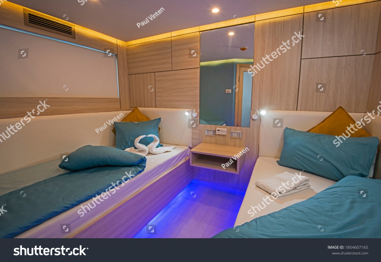 stock-photo-interior-of-cabin-bedroom-on-luxury-sailing-yacht-with-twin-beds-1854607165.jpg